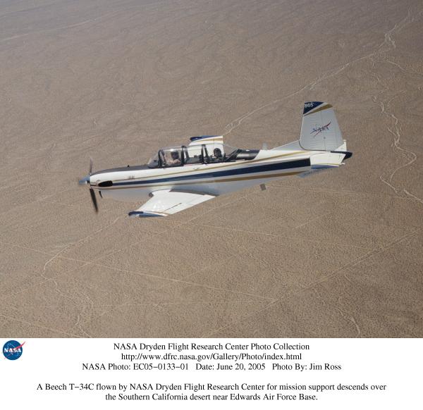 A Beech T-34C flown by NASA Dryden Flight Research Center for mission support descends over the Southern California desert near Edwards AFB.