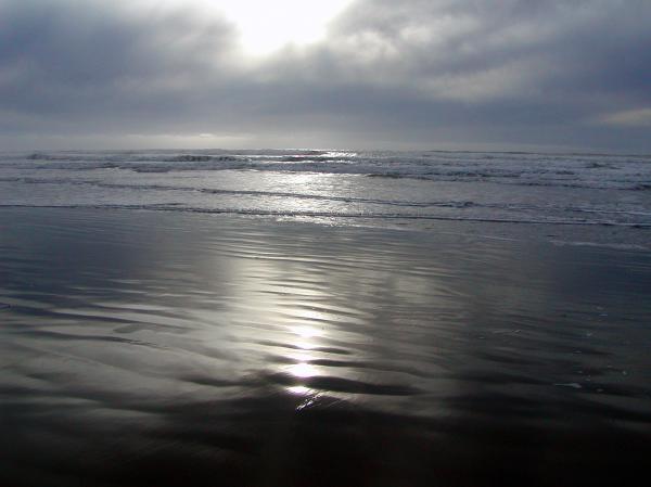 A clear patch of beach with a thin layer