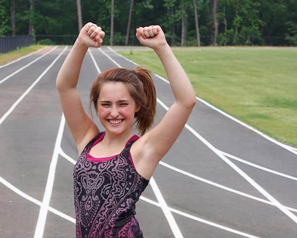 A cute young girl on a track field