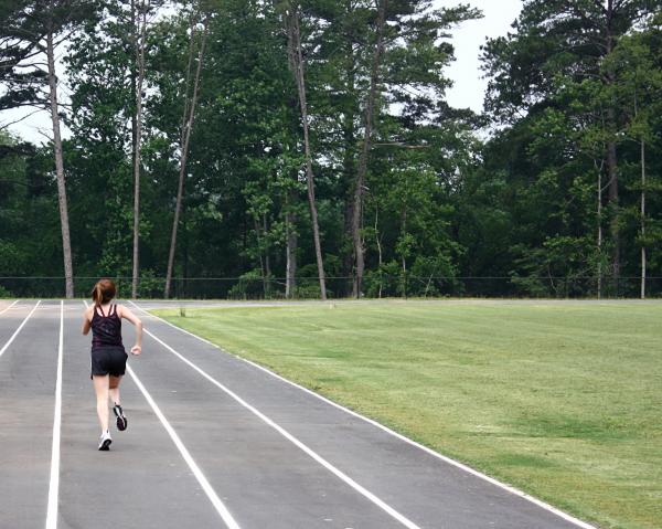 A cute young girl on a track field