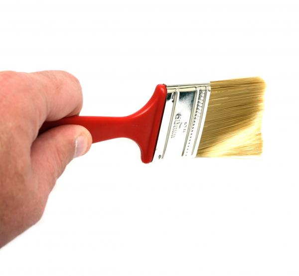 A hand holding a paint brush