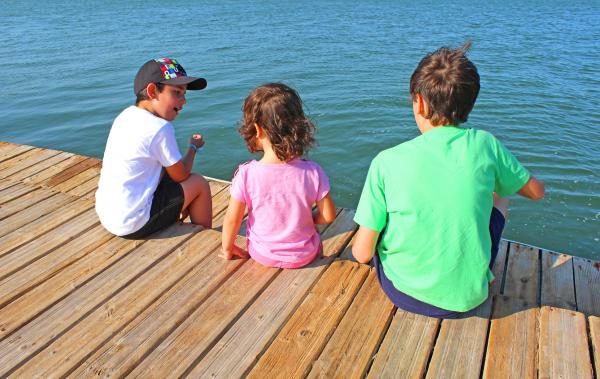 A little boy talking with friends