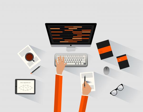 A software engineer programming at the desk