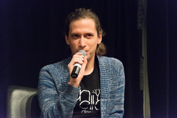 Aaron Lemke (Unello Design) discussing at indie dev panel at SVVR (microphone at mouth looking stage left)