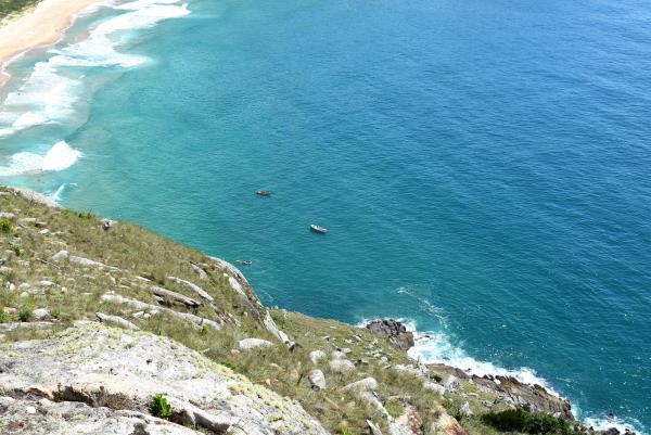 Aerial Photography of White Boat on Body of Water Near Seashore