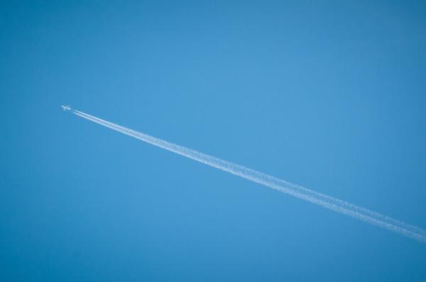 airplane flying through blue sky