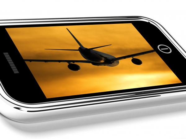 Airplane Flying Towards The Sunset Picture On Mobile Phone