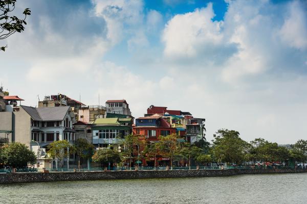 Assorted-color Buildings Near Water and Trees