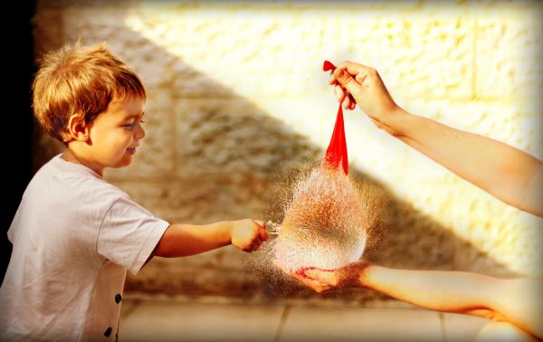 Baby Boy Popping A Balloon