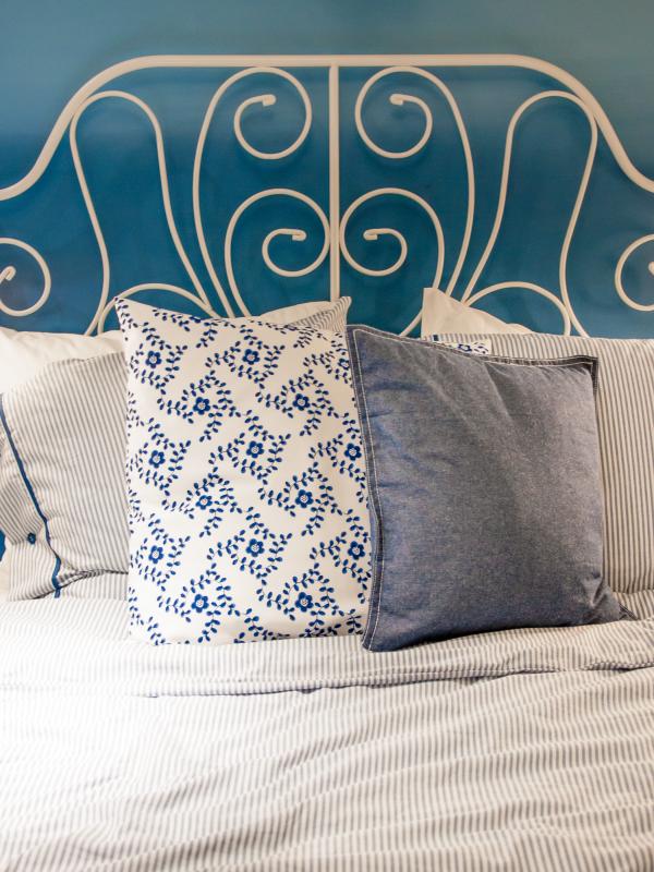 bed with blue linen in the bedroom