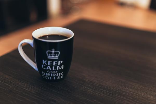 Black and White Ceramic Mug on Wooden Table
