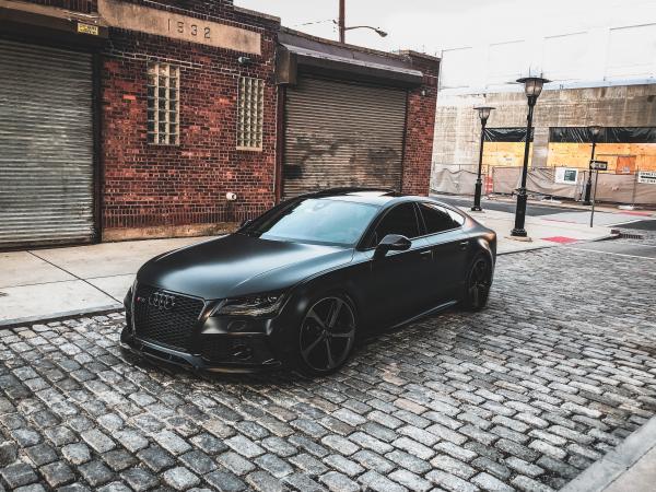 Black Audi A-series Parked Near Brown Brick House
