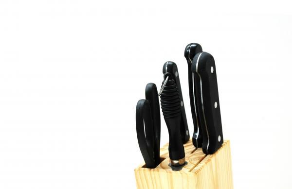 Black Handled Kitchen Knife on Beige Wooden Pallet