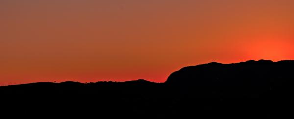 Black Mountain Under Brown Sky during Sunset
