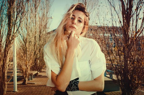 Blonde Woman in White Dress Shirt Beside Brown Plants