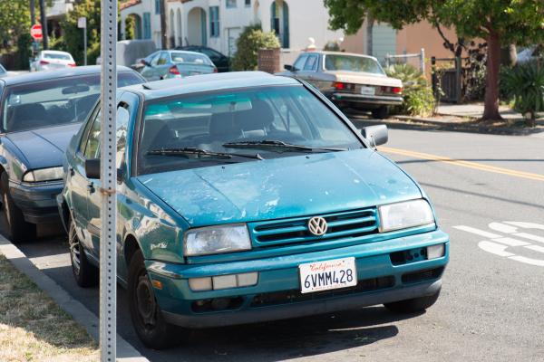Blue Volkswagen by street corner in Berkeley