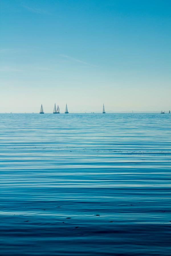 Boats on Body of Water Under Blue Sky