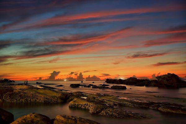 Body of Water Near Rock Formation during Orange Sunset