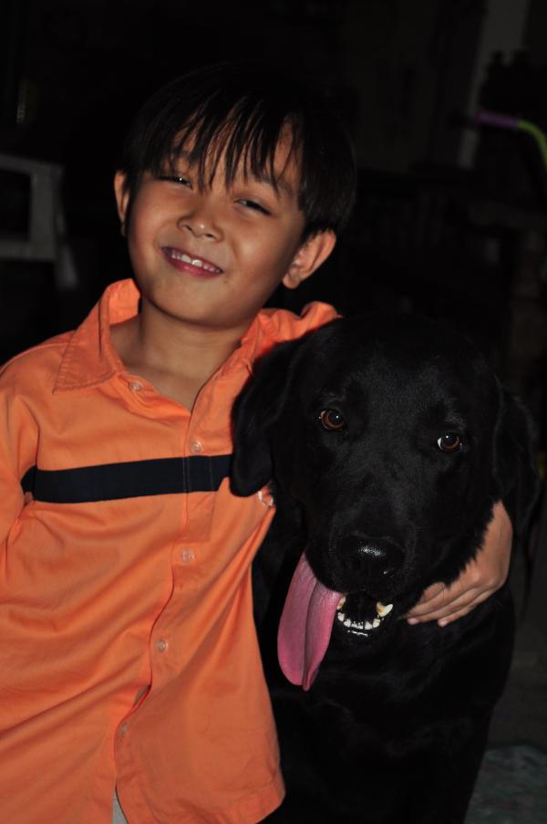 Boy and black Labrador