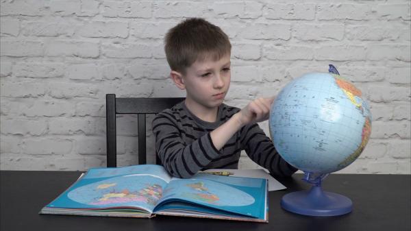Boy learning georgraphy