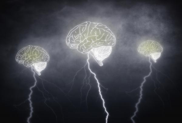 Brainstorming - Three brains with thunderbolts on cloudy sky