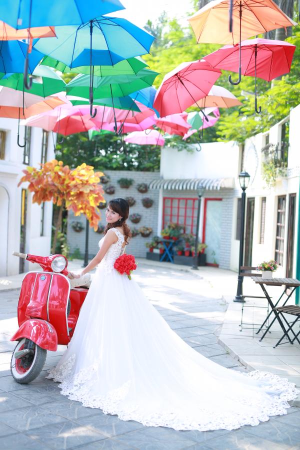 Bride posing with red scooter