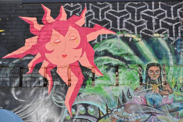 Bright original graffiti on a wall of black brick