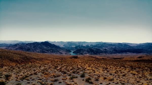 Brown Sand Near Mountain Under Cloudy Sky