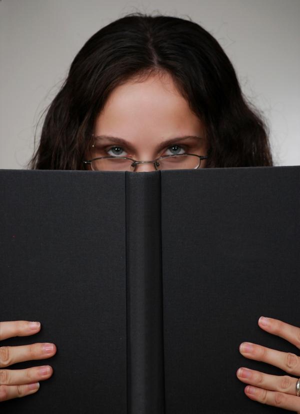 Business woman looking over a book