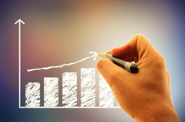 Businessman drawing a financial graph