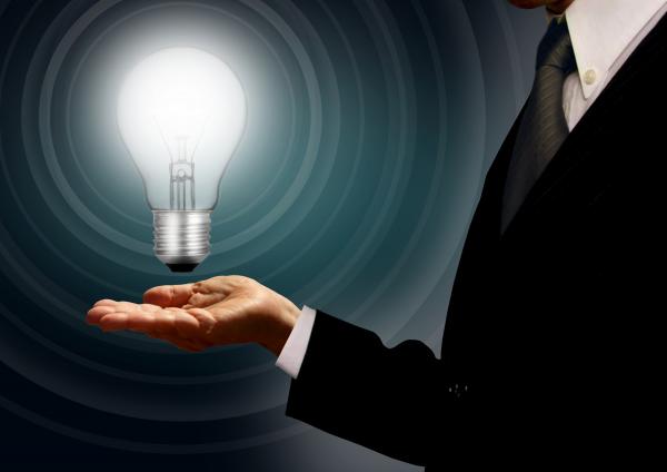 Businessman holding a lightbulb