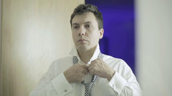 Businessman Straightening Shirt