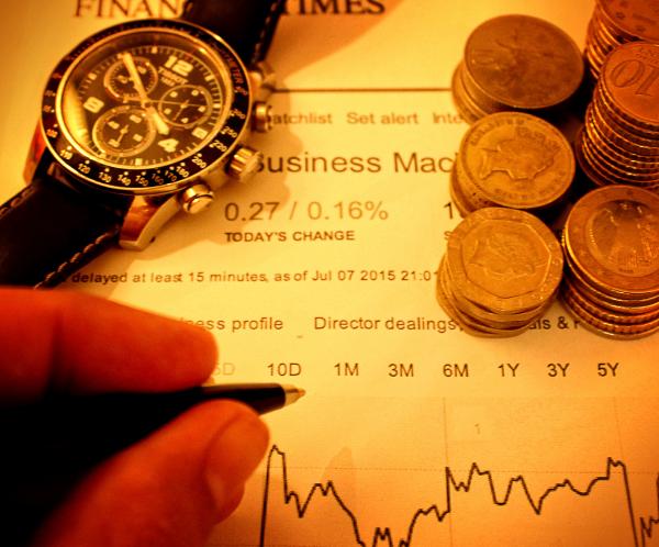 Businessman With Pen Over Financial Data