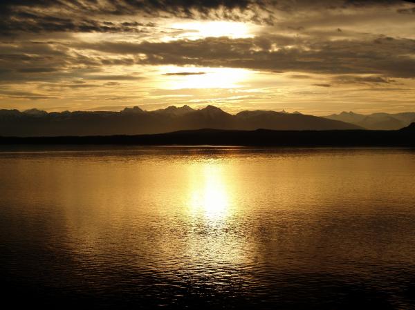 Calm Sea Near Mountain at Sunset