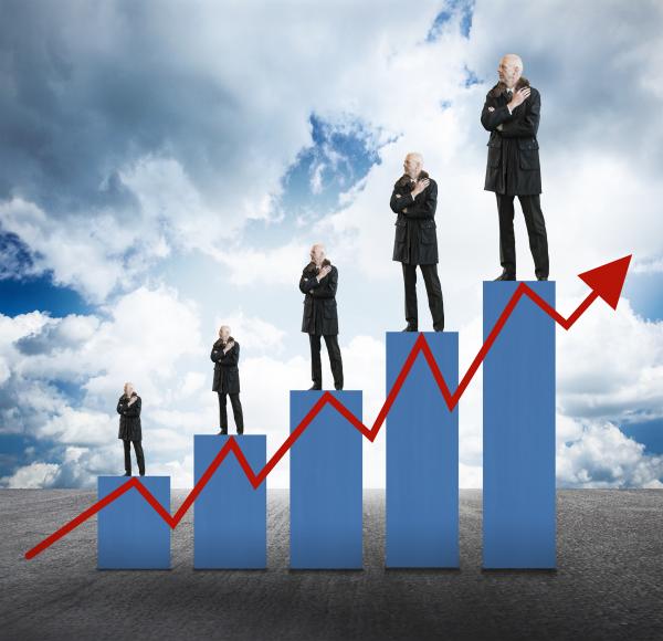Capital Appreciation - Businessmen on Bar Chart with Arrow