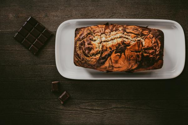 Chocolate Cake In White Plate Beside Chocolate Bars