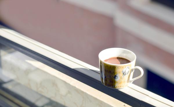 Coffee in White and Yellow Ceramic Mug on White Surface