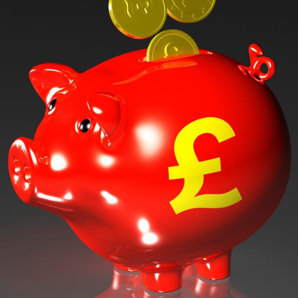 Coins Entering Piggybank Showing British Investing