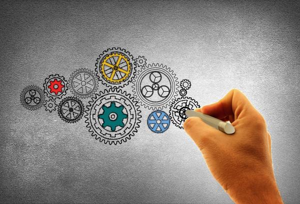 Concept of Work - A Person Drawing Cogwheels