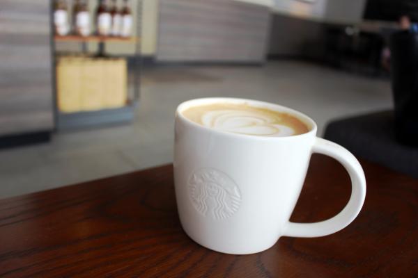 Cup of hot coffee in Starbucks with logo on the cup