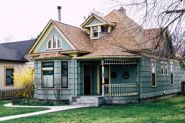 Cute blue country house with a green lawn