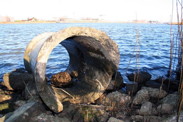 Damaged pipeline half in the water
