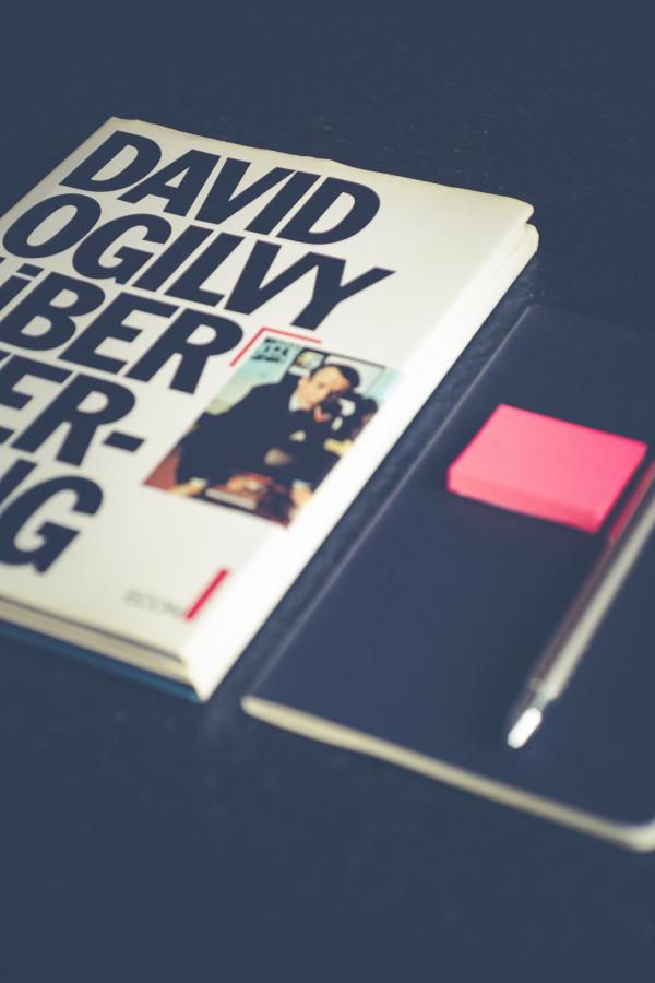 David Ogilvy Book Lying Beside Black Leather Booklet