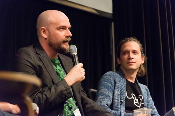 Denny Unger of Cloudhead Games) answering question at indie dev panel (from side of stage) with Aaron Lemke (Unello Design) looking on