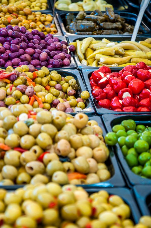 Different marinated olives in market