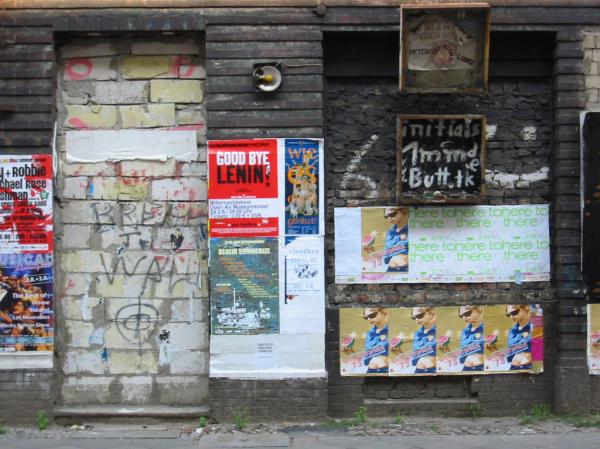 Dirty wall with posters and graffiti