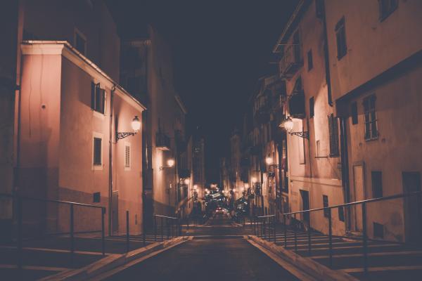 Empty Concrete Road in the Middle of Concrete Buildings at Night