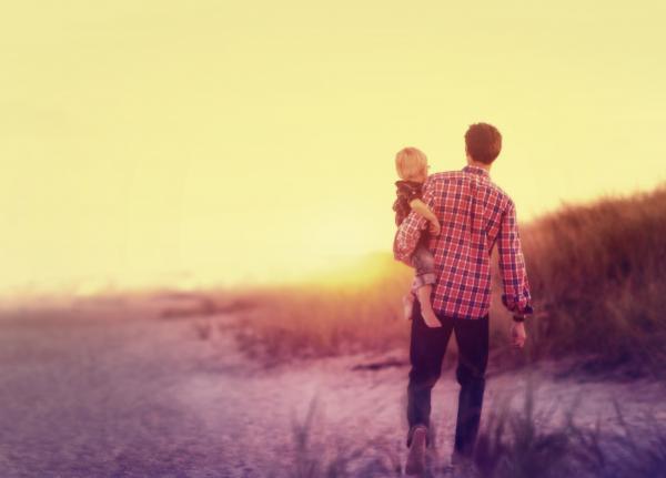 Father Holding His Baby on the Beach