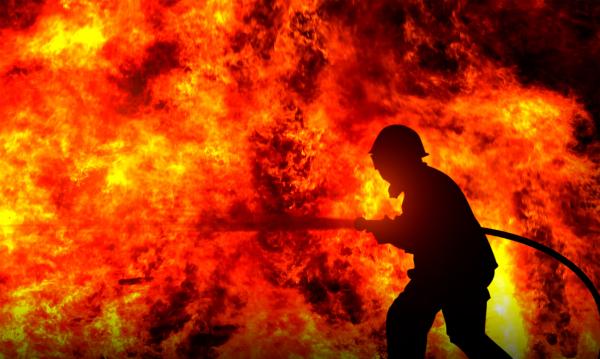 Firefighter Fighting a Raging Wildfire