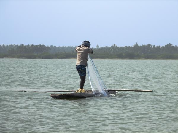 Fisherman in a log boat